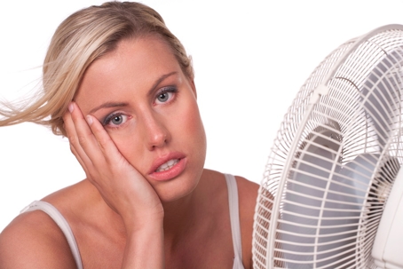 woman sitting in front of fan