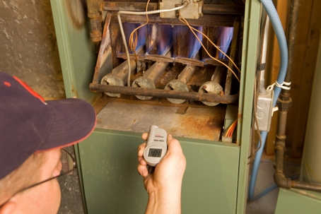 man checking a furnace