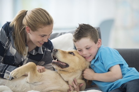 woman and little petting a dog