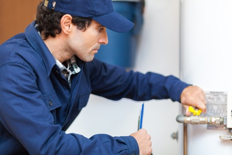a guy working on a pipe valve