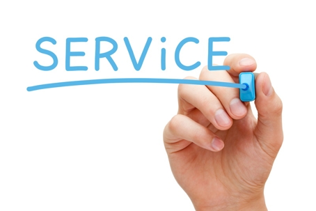 a hand writing the word service in blue