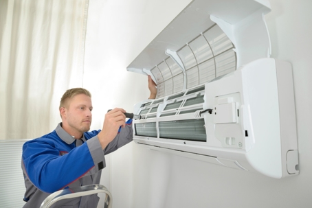 man checking a mini-split system